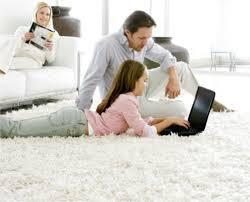 Dad and daughter working on laptop on carpet cleaned by Peace Frog Carpet & Tile Cleanign in Austin