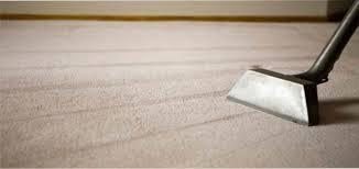 Steam cleaner working a white carpet, leaving clean lines