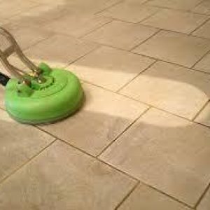 Dirty tile floor in the middle of tile and grout cleaning by Peace Frog Specialty Cleaning in Austin