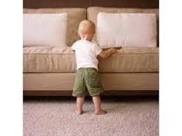 Toddler standing in front of clean couch