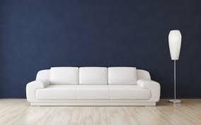 Freshly cleaned white couch in room against a dark blue wall