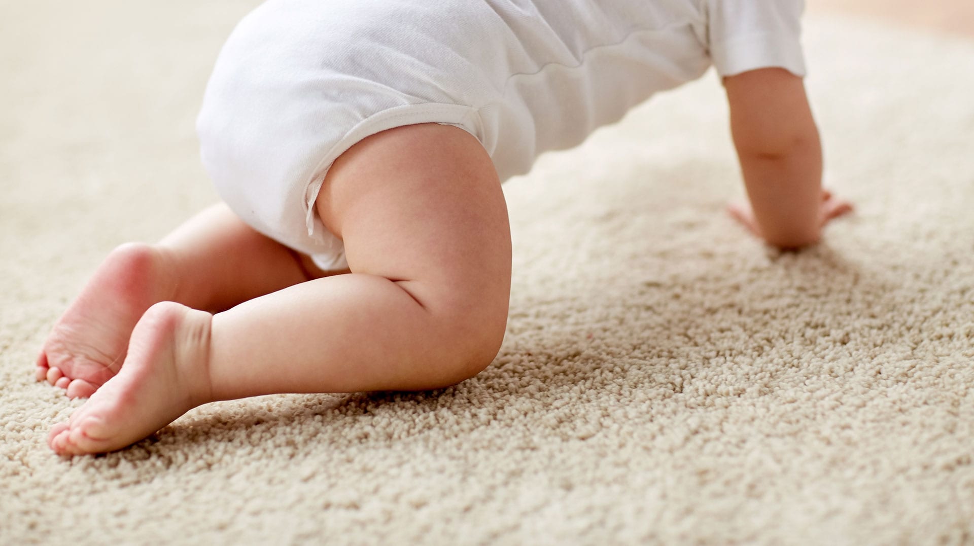 baby crawling on clean carpet