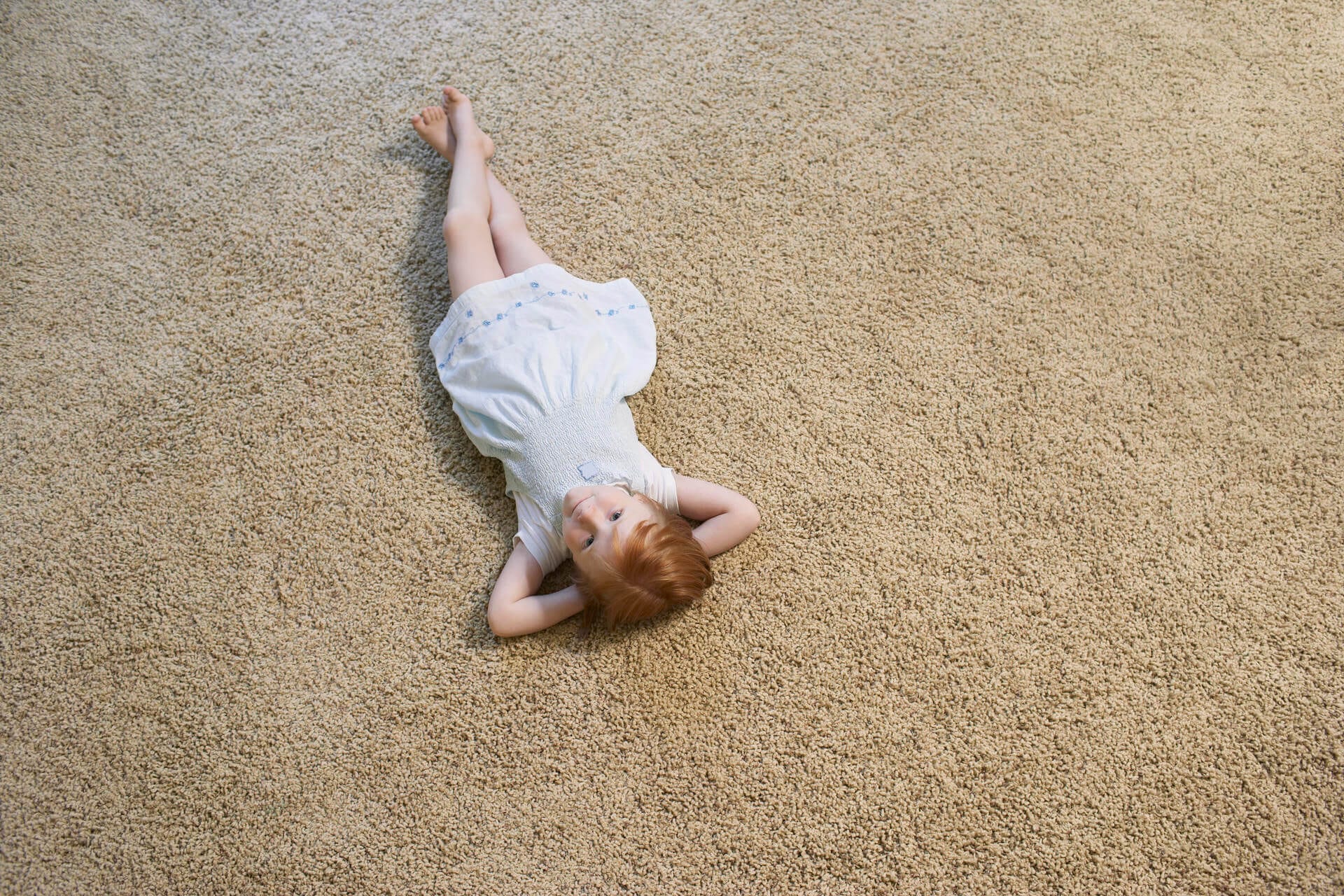 girl lying on carpet