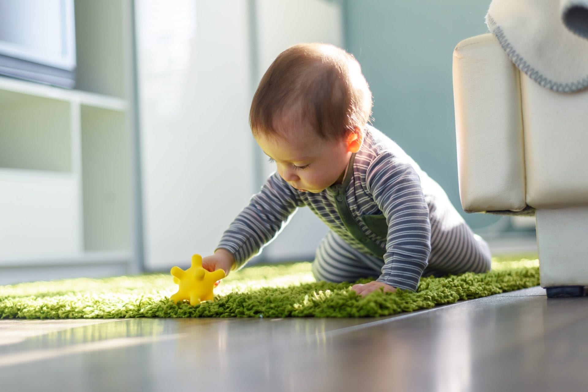 toddler on green shag rug